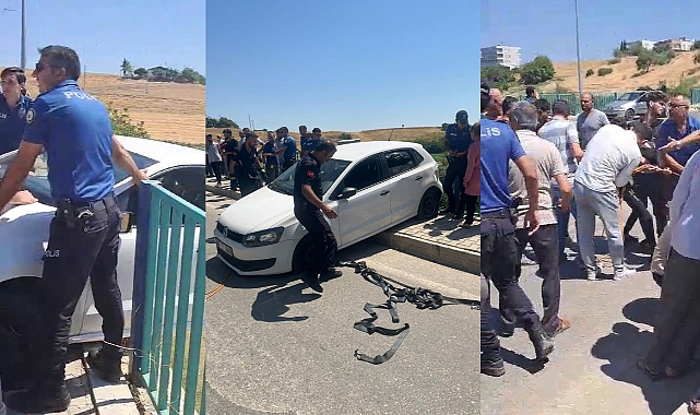 Köprüde asılı kalan otomobil düşmesin diye üzerine çıktılar
